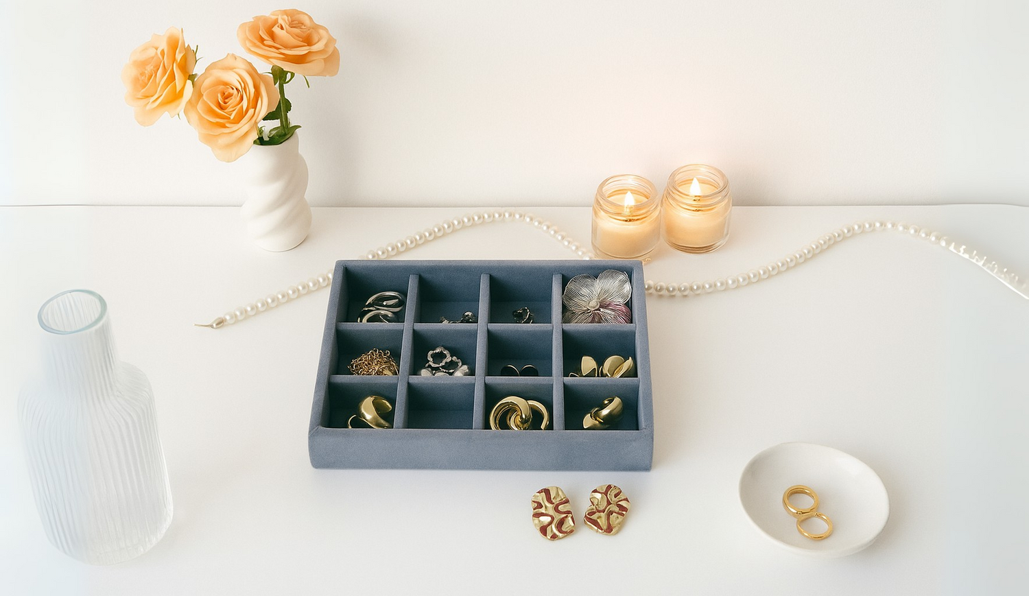 “Elegant 12-slot grey velvet jewellery organizer tray displayed on a white surface.