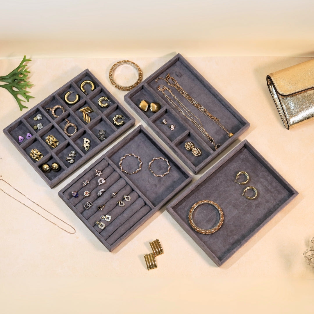 Velvet jewelry organizer trays for earrings, rings, bracelets, and necklaces.