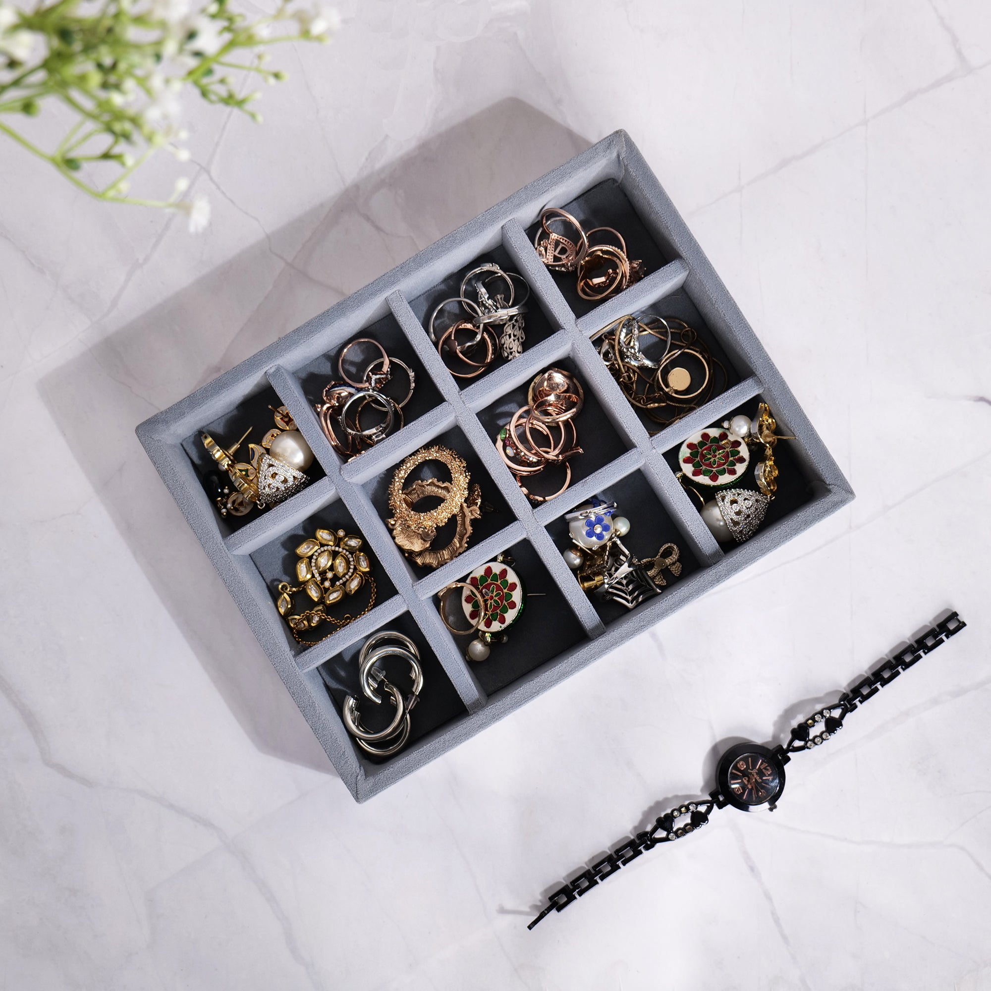 Grey 12-grid jewellery organizer tray with soft lining.