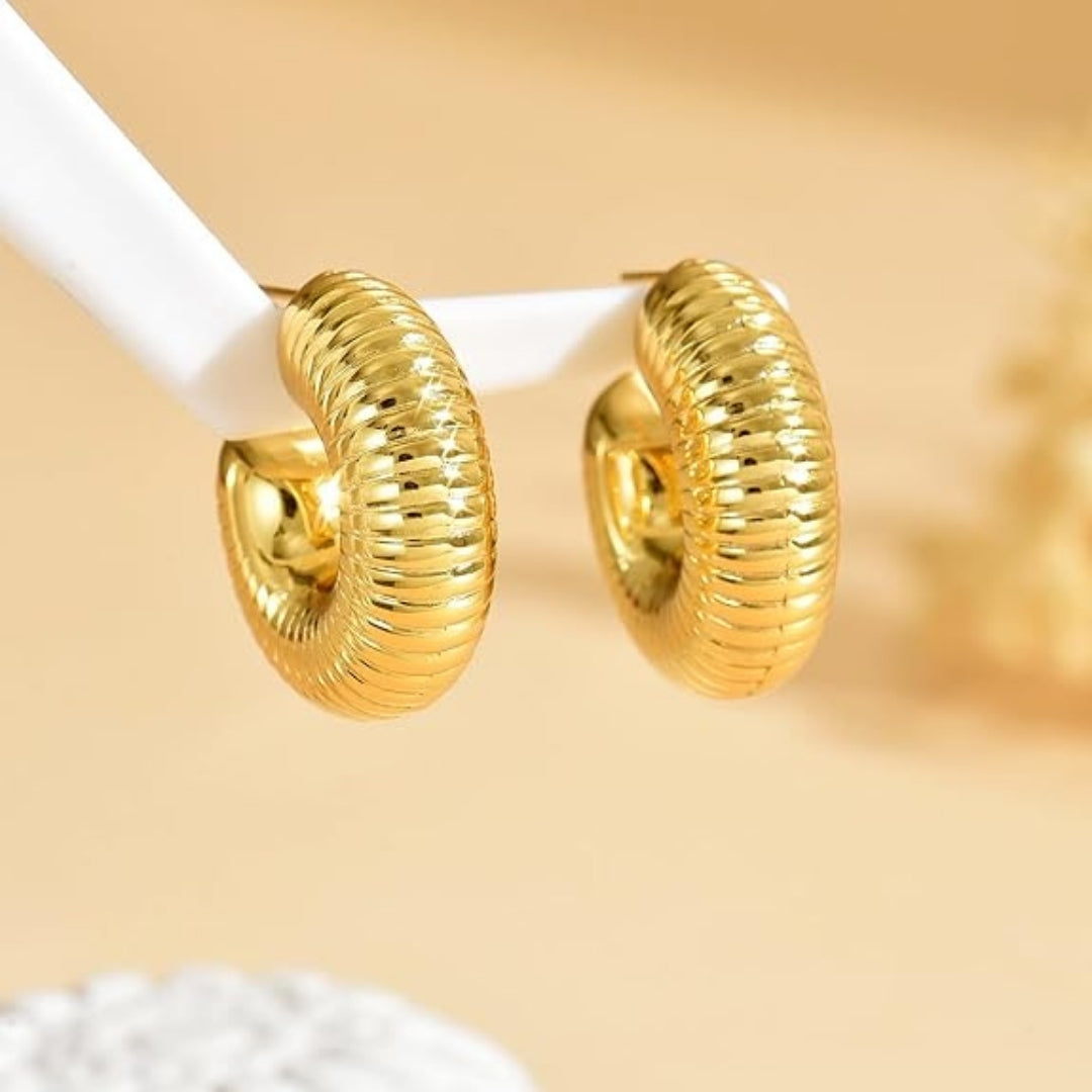 Ribbed Gold Hoop Earrings on white background.
