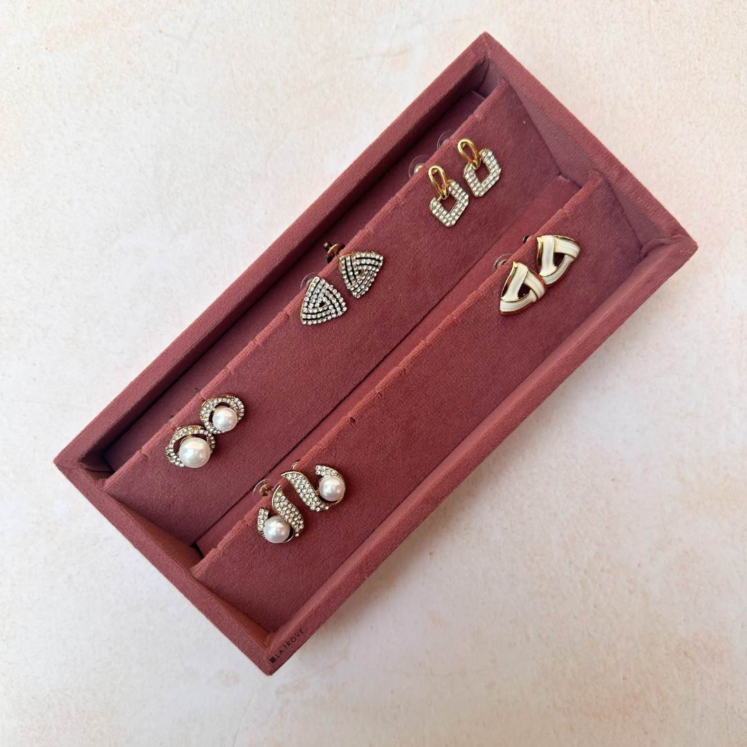 Dark pink velvet earring organiser tray with pre-cut holes and soft rows.
