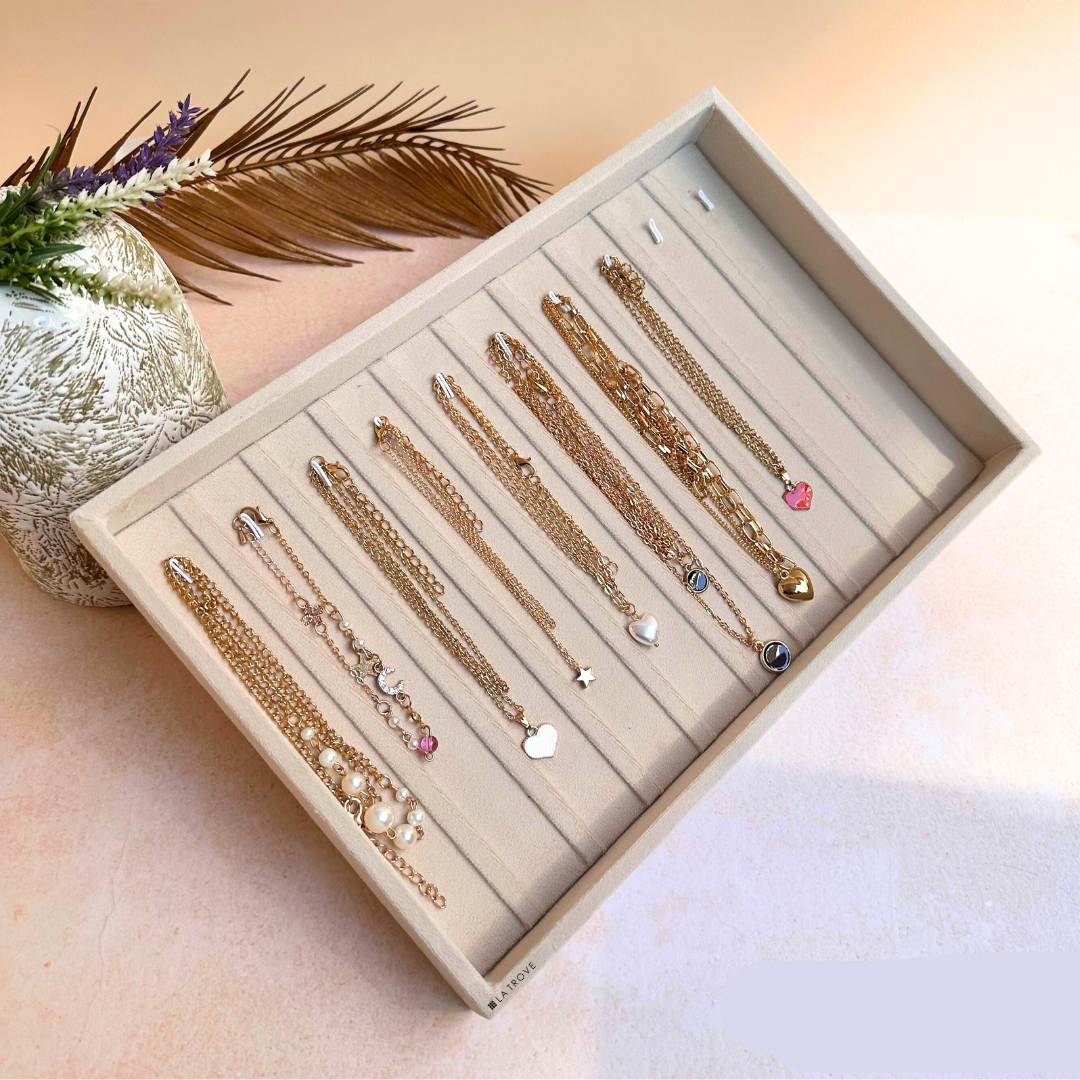 Cream velvet jewellery tray for storing bracelets and chains neatly.