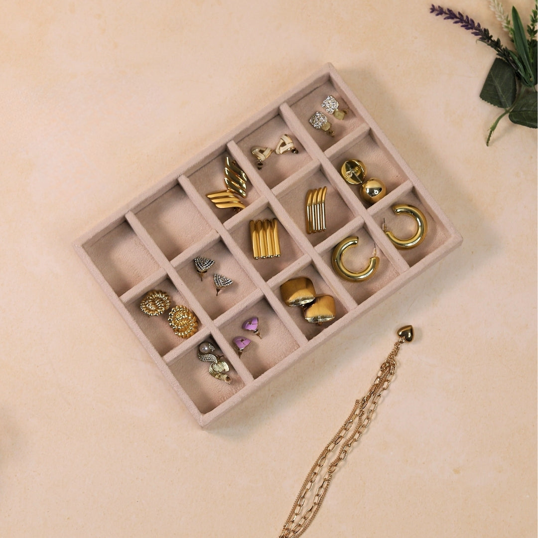 Cream velvet 15-slot jewellery tray for earrings and rings.