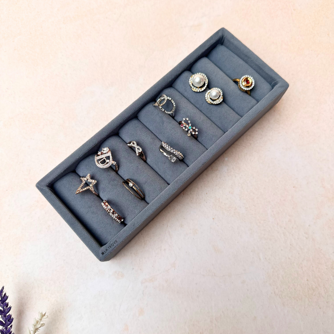 Grey velvet ring and cufflink tray for secure storage of small accessories.