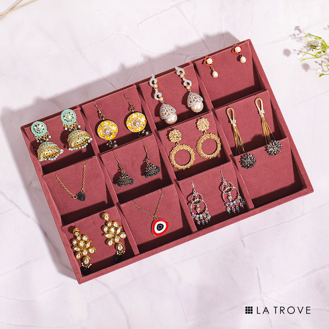 Dark pink earrings tray with multiple slots for jewellery storage.