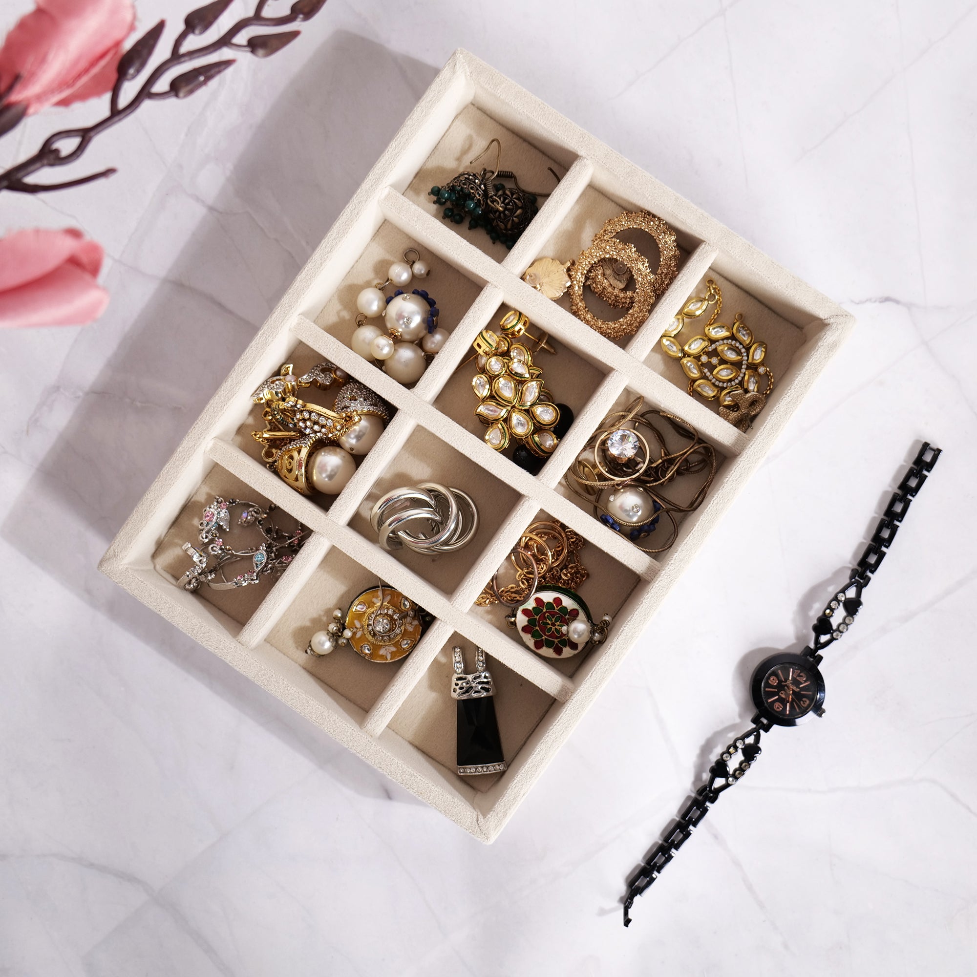 Cream velvet 12-slot jewellery tray for rings and earrings.