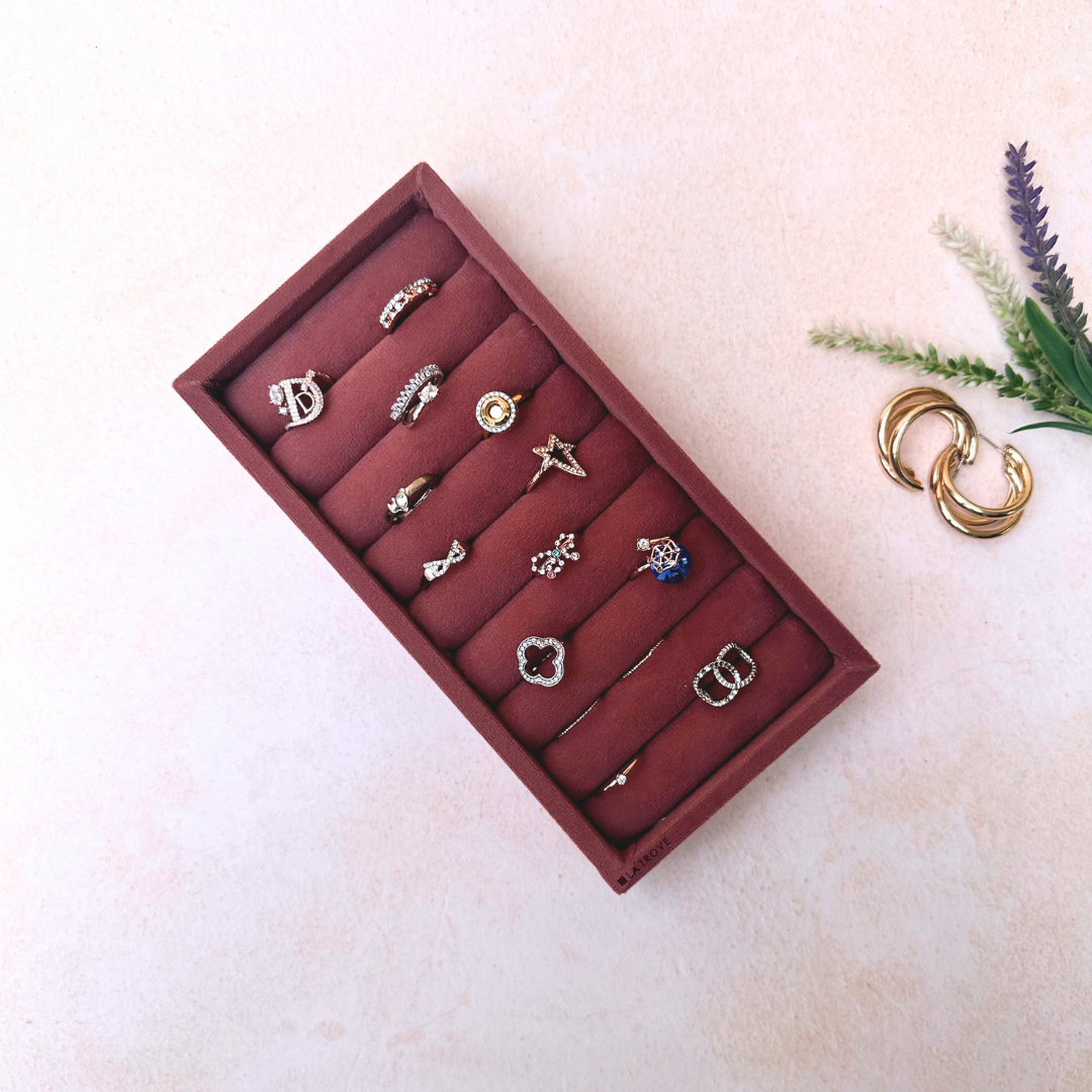 Dark pink velvet ring organiser tray featuring soft cushioned sections for jewelry.