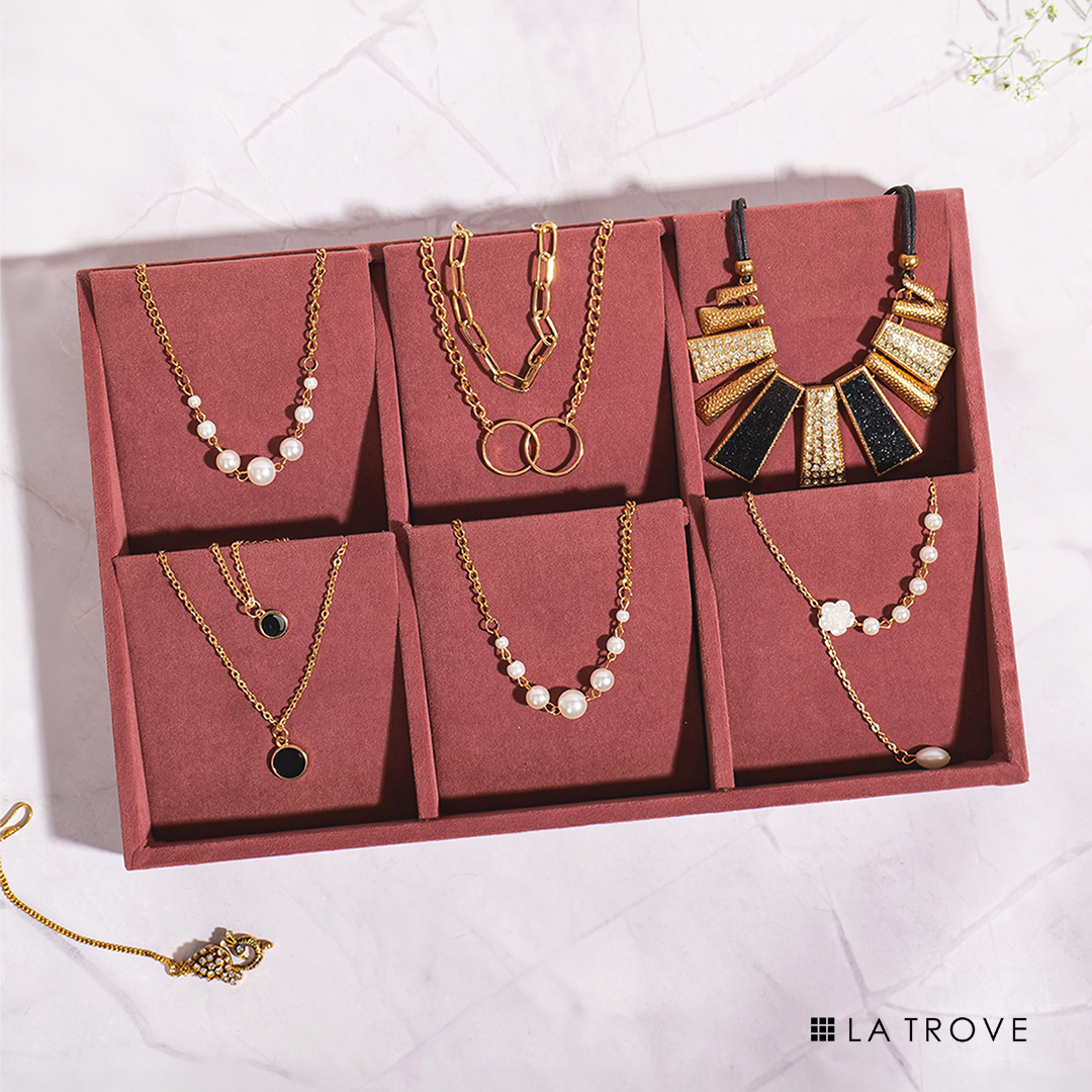 Dark pink necklace organizer tray with soft velvet lining.