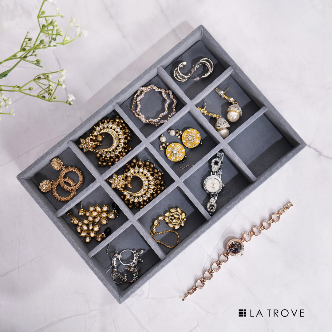 Grey jewellery organizer tray with 12 soft-lined compartments.