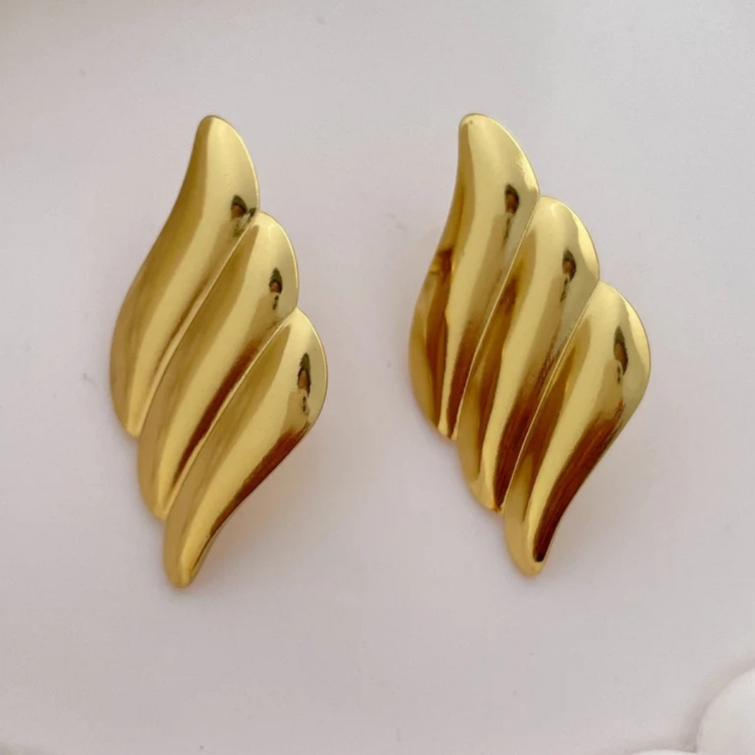 Wave inspired gold statement earrings luxury jewelry.