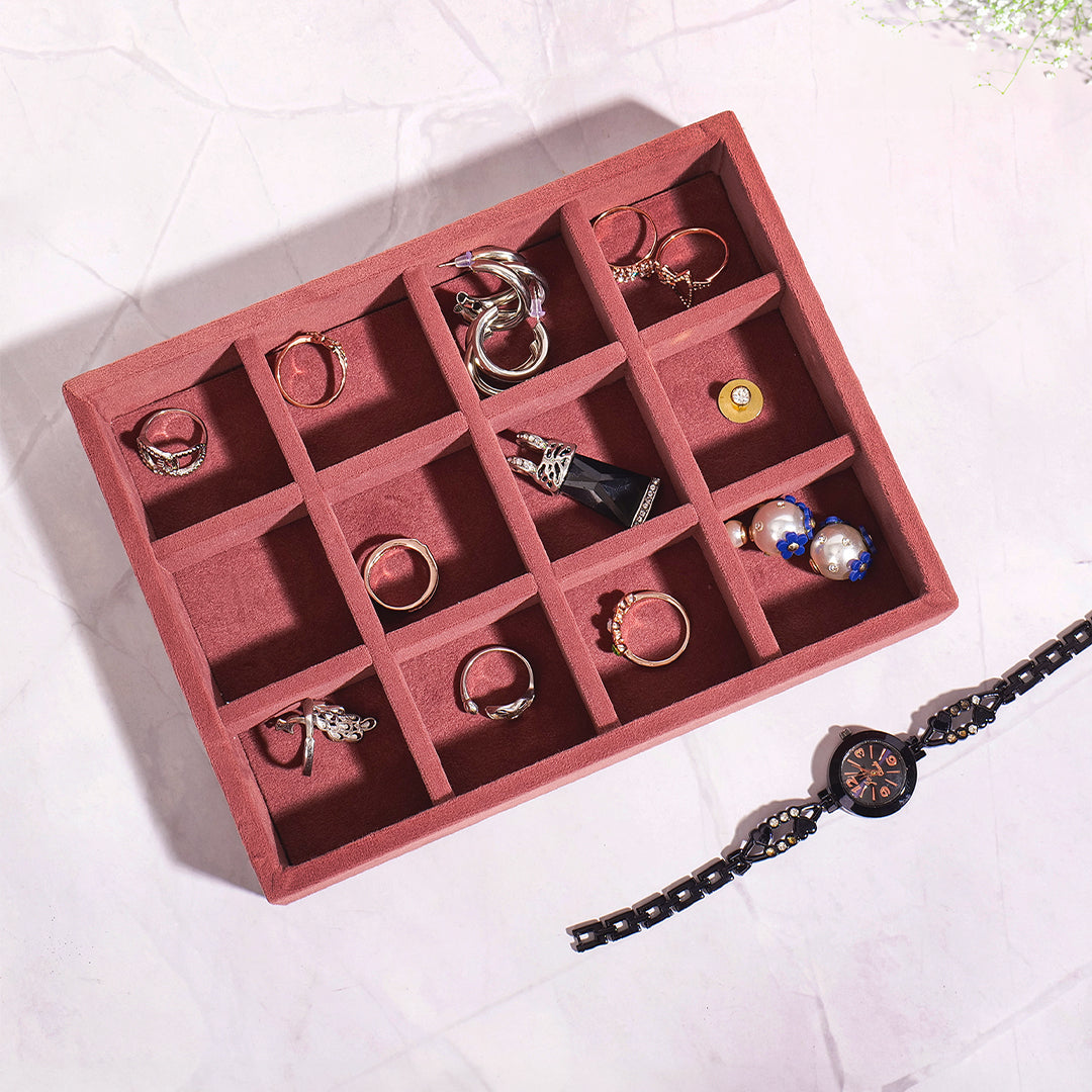 Dark pink jewellery tray with 12 compartments for accessories.