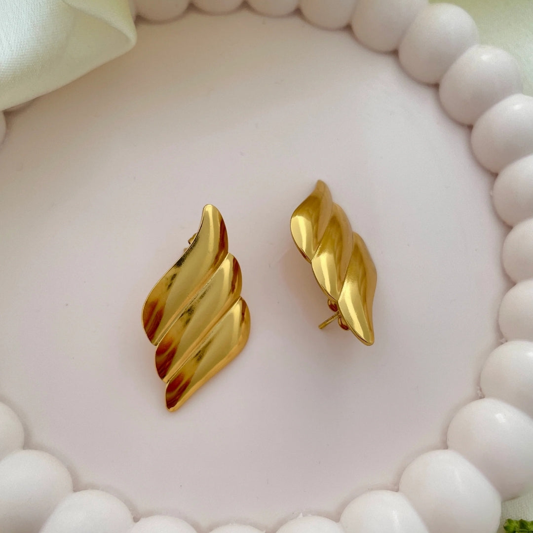 Bold statement earrings in gold finish for parties.
