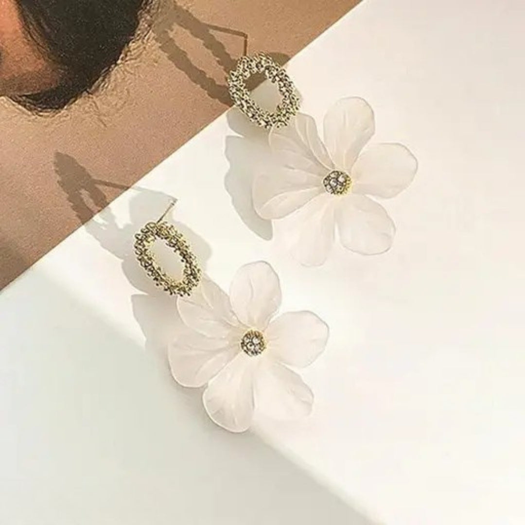 Frosted floral dangle earrings for women on white background.