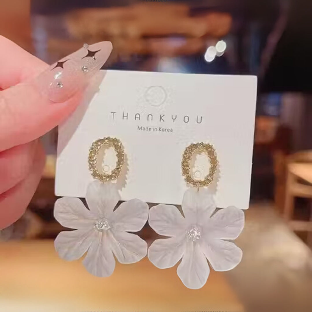 Elegant floral earrings with frosted design close-up.