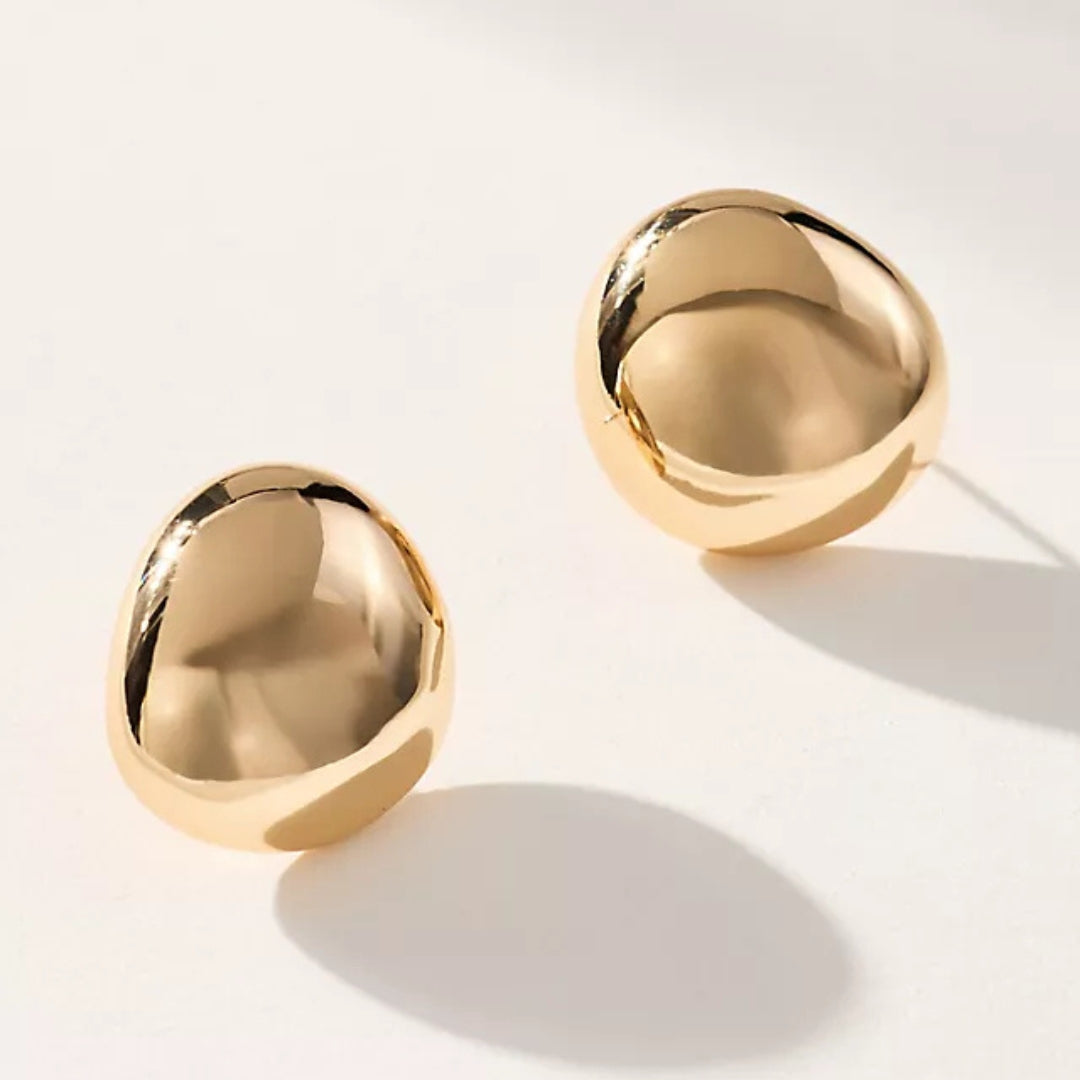 Minimalist gold stud earrings with polished shine.